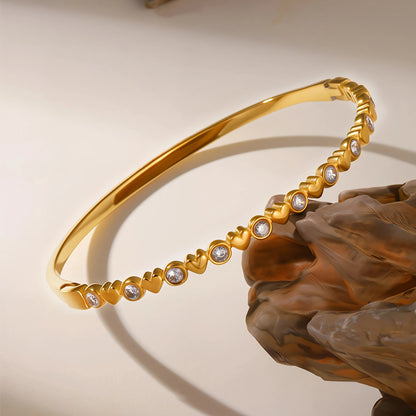 Heart-detail bangle with bright round accents