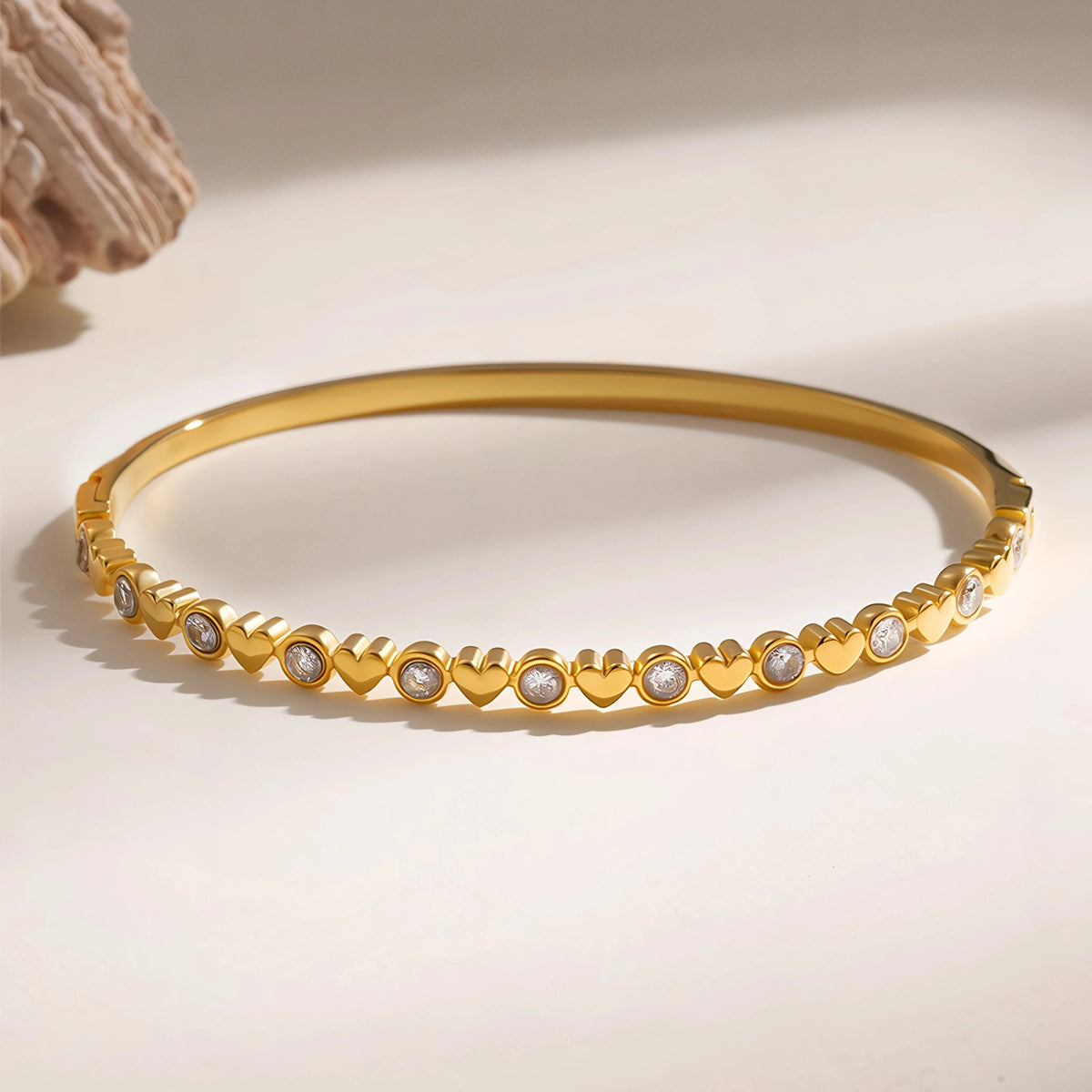 Heart bangle resting on a light surface