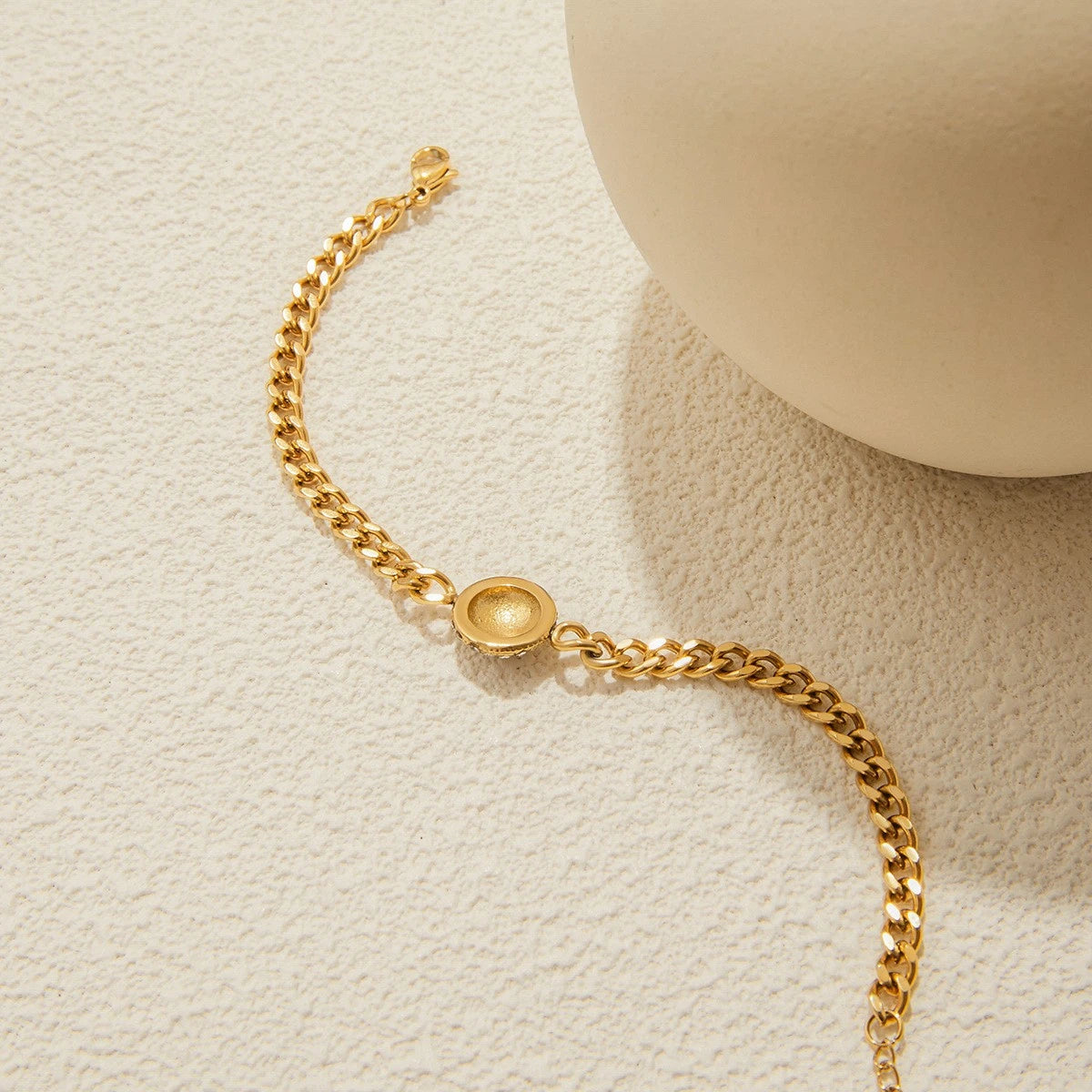The Orbit Gold Pavé Crystal Ball Chain Bracelet — worn on wrist close-up showing pavé crystal ball charm and gold Cuban link chain