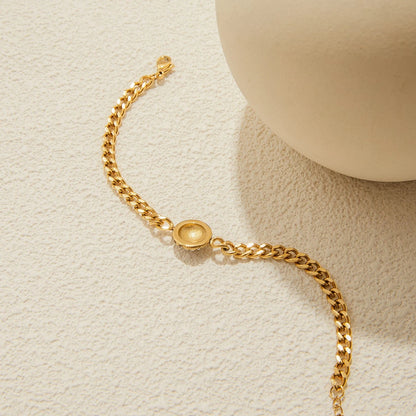 The Orbit Gold Pavé Crystal Ball Chain Bracelet — worn on wrist close-up showing pavé crystal ball charm and gold Cuban link chain