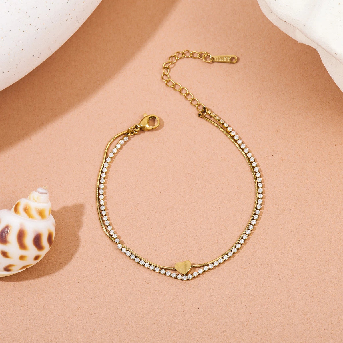 The Duo Gold Heart Charm Double Layer Bracelet — worn on wrist showing double-layer silhouette with heart charm centred on snake chain