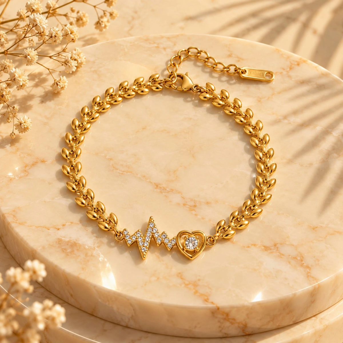 Gold-tone leaf-link bracelet with sparkling heartbeat and heart charms