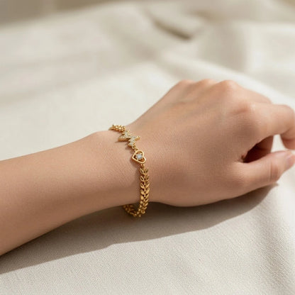 Close-up of heartbeat and heart charms on the bracelet