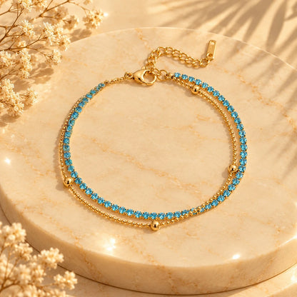 Layered styling with the blue double-row bracelet